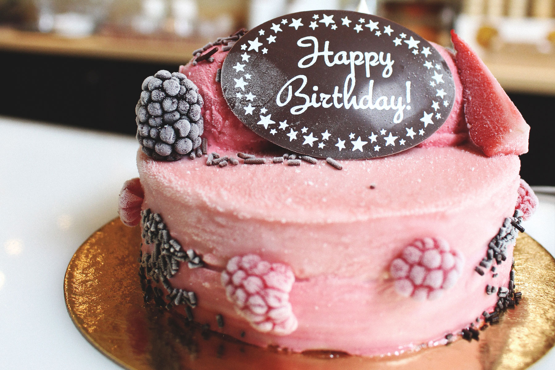 berry cake with happy birthday plaque